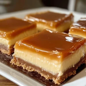 Creamy caramel cheesecake squares on a decorative plate