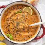 Creamy Marry Me Lentils in a sun-dried tomato sauce, served with bread and garnished.