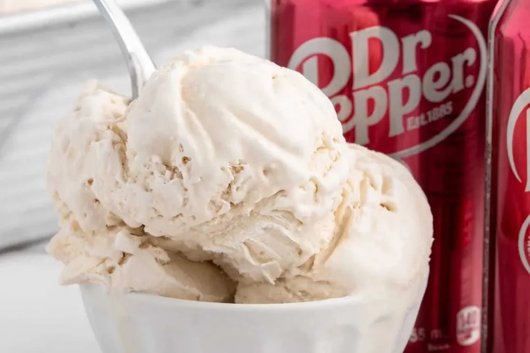 Dish of creamy Dr Pepper ice cream topped with chocolate sauce and cherries