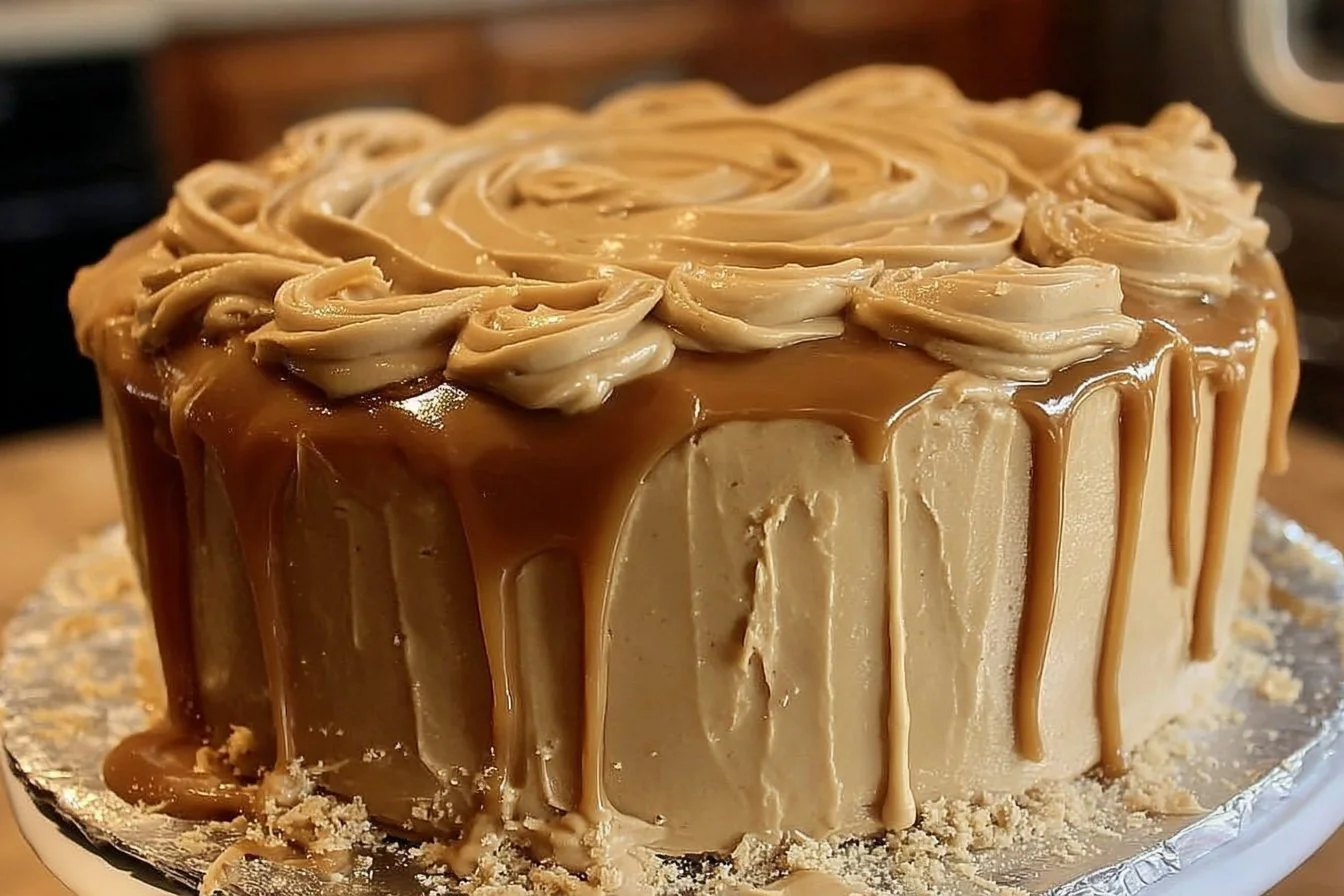 Delicious Baptist Pound Cake topped with caramel icing on a decorative plate.
