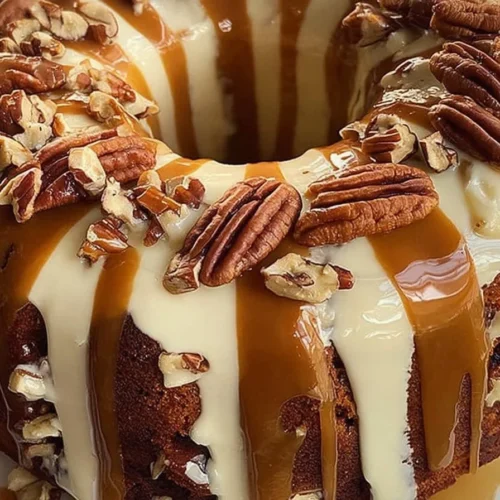 Delicious cinnamon roll cream cheese caramel pecan pound cake on a plate