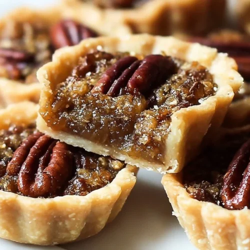 Delicious mini pecan pies served on a plate, perfect for dessert lovers.